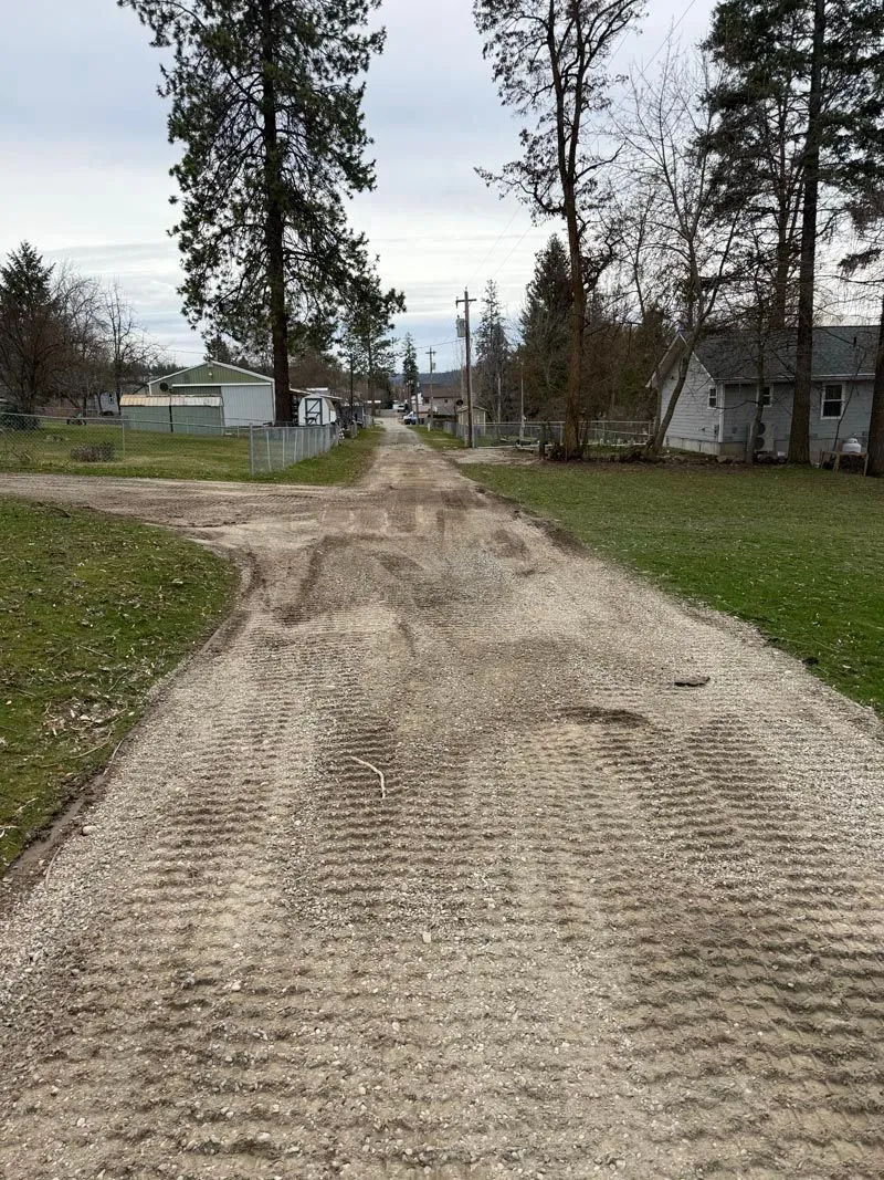 Smoothed and compacted dirt lane between grassy shoulders
